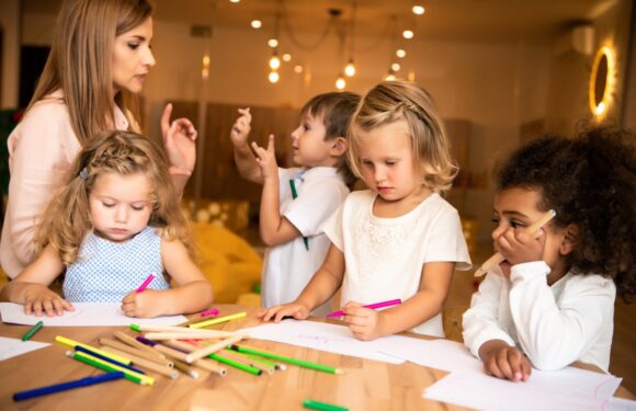 Children engaged in creative activities with a teacher in a nurturing classroom environment, representing high-quality childcare in Surrey BC.