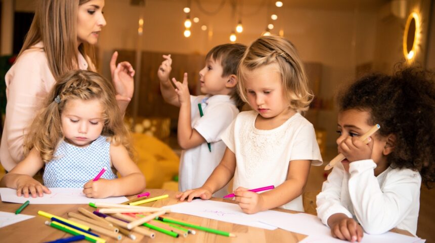 Children engaged in creative activities with a teacher in a nurturing classroom environment, representing high-quality childcare in Surrey BC.