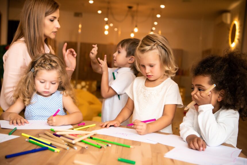 Children engaged in creative activities with a teacher in a nurturing classroom environment, representing high-quality childcare in Surrey BC.